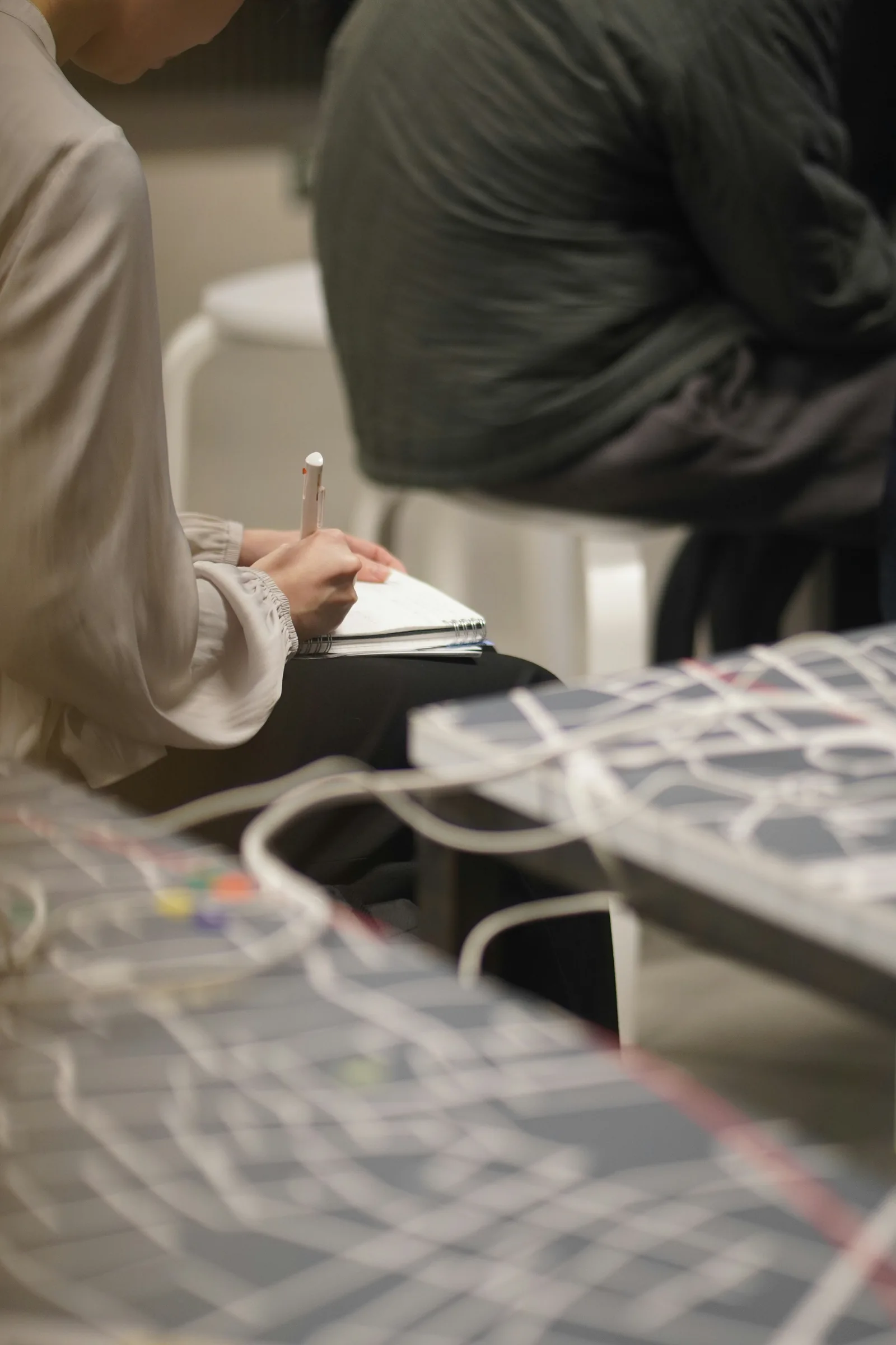 A participant capturing ideas in a notebook during a working session.